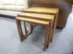 A nest of 3 teak coffee tables