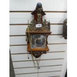 Brass and wood weighted clock with chime bell depicting Atlas