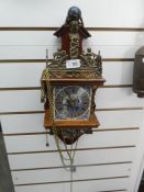 Brass and wood weighted clock with chime bell depicting Atlas