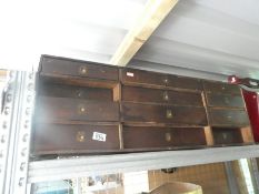 Small wooden drawers and a larger wooden storage unit