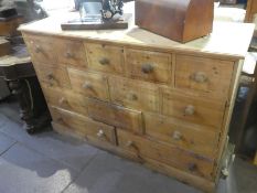 Large stripped pine bank of 14 graduating drawers, AF