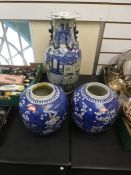 An antique Chinese blue and white vase decorated temples and buildings, chip to rim, 46cms, and two