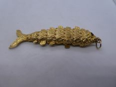 9ct yellow gold articulated fish design pendant, with garnets set for the eyes, 8cm length, marked 3