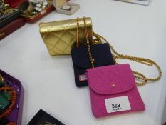 Two small Chanel purses and an Estee Lauder example