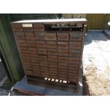 Large metal storage unit with 6 rows of small drawers