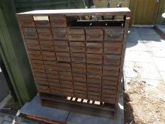 Large metal storage unit with 6 rows of small drawers