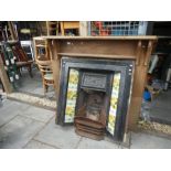 Cast iron fire insert with floral side tiles, ornate insert and wooden fire surround