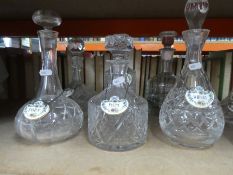 A selection of glass decanters, some with labels and vintage soda syphons