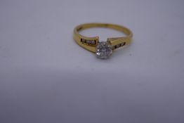 18ct yellow gold solitaire diamond ring, the shoulders set with diamonds, marked 750, size size O, 2