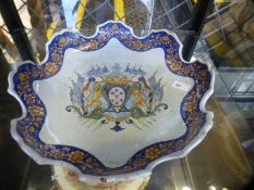 A French Faience Armorial plate having shaped rim, possibly 18th Century 27.5cm and a Chinese export