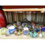 A selection of glass paperweights, including one by Wedgwood
