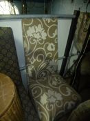 two Lloyd loom laundry baskets and a beige floral chair