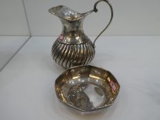 A silver jug with half reeded decoration, marked H and A  100, along with a silver Octagonol dish ma