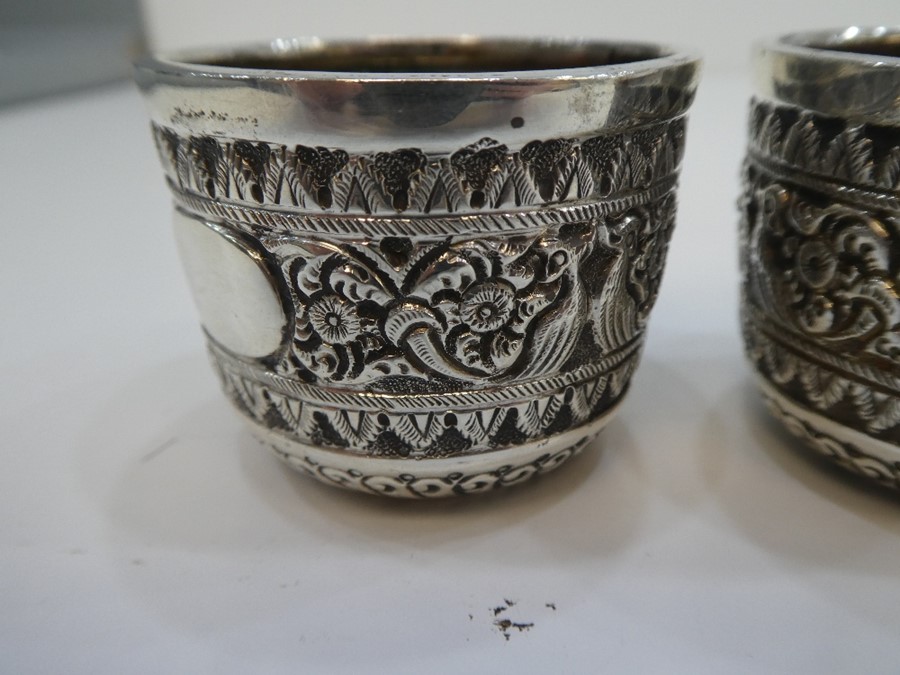 A set of three Victorian silver small embossed cups very decorative and ornate. Hallmarked London 18 - Image 3 of 3