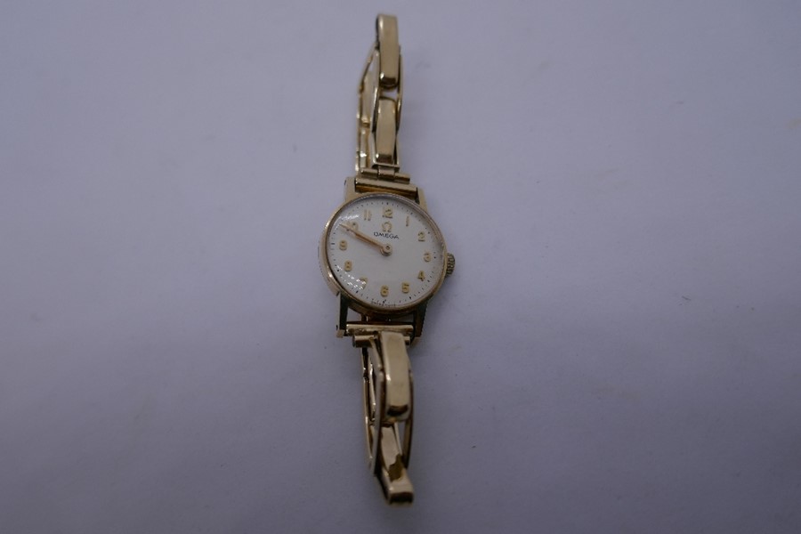 Vintage 9ct yellow gold ladies 'Omega' wristwatch with champagne dial and gold numbers, 3 strap link