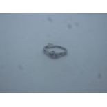 Platinum diamond ring in pretty crossover setting, central diamond approx 0.25 carat, inscribed FORE