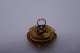 Unmarked yellow metal mourning brooch/pendant inset with amethyst and clear stones, in a floral desi