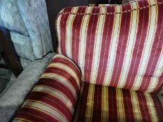 A large 3 seater sofa on castors with gold and red stripes
