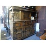 A Reproduction oak court cupboard having carved decoration and a similar cocktail cabinet