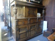 A Reproduction oak court cupboard having carved decoration and a similar cocktail cabinet