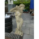 A large hollow resin statue of a semi clad lady