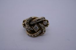 9ct yellow gold knot ring set with clear stones marked 375, 17.6g