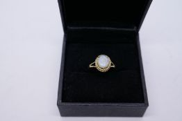 Pretty 9ct yellow gold dress ring with oval white opal, size N, 1.8g, marked 375