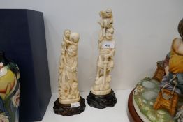 Two Japanese ivory figures, one signed to the base, the largest, 26 cms