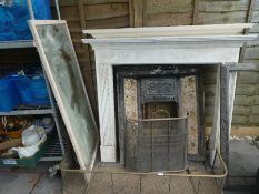 Cast iron tiled fireplace, with two wooden surround, brass fender, mirror, etc
