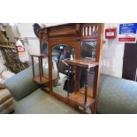 An early 20th century walnut over mantle mirror