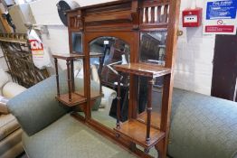 An early 20th century walnut over mantle mirror