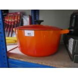 A large Le Creuset orange cooking pot