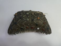A Saudi Arabian white metal purse with different coloured stones