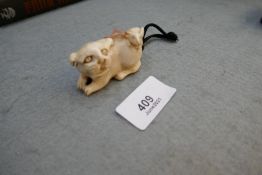 A 19th century Japanese ivory netsuke in form of dog and rabbit