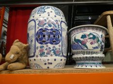 A large ceramic pot stand with pot, oriental designs