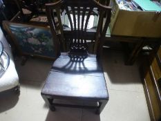 A single wooden carved back chair