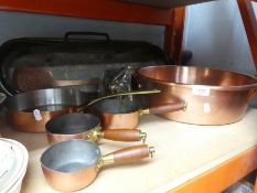 Selection of copper dishes and pans - some with brass and wooden handles