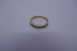 9ct yellow gold channel set diamond band ring, size O, 2.6g, marked 375