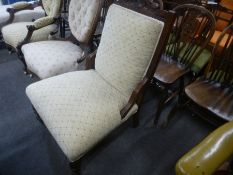 A late Victorian Walnut fireside chair having carved decoration