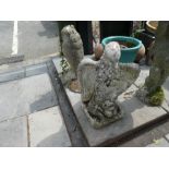 Two stone effect bird figures, an owl and an eagle