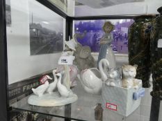 A selection of Nao figures, cats, birds, elephants, etc