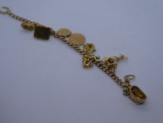 9ct rose gold charm bracelet hung with 9 charms incl. baby in a crib, house, horse shoe etc, 30.3g A