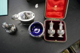 Two silver salts with Bristol blue inserts, a silver pepper and a cased set of two very nice peppers