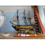 A wooden model of HMS Victory and a metal model of a cannon