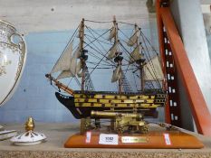 A wooden model of HMS Victory and a metal model of a cannon