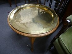 A circular brass tray top table on cabriole legs
