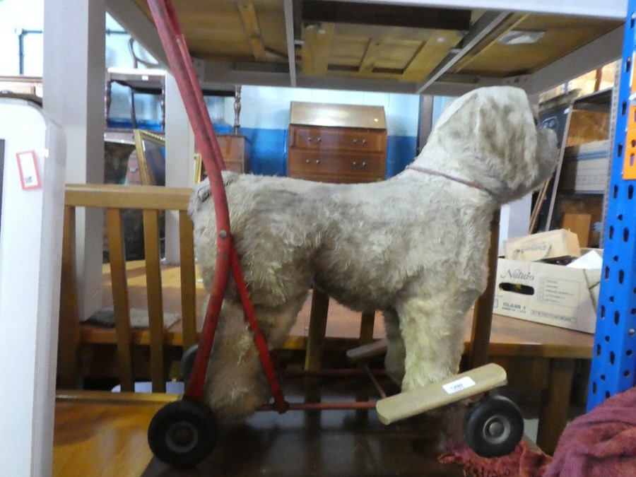 A vintage push along toy dog