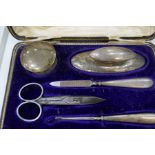 A silver Edwardian hallmarked manicure set Birmingham 1913/14, E S Barnsley and Co. and white metal