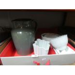 A box containing various china jelly moulds and a large Studio pottery glazed jug