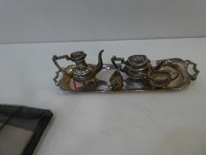 A very pretty, decorative miniature silver tea set comprising of a tray, tea and coffee pot and two